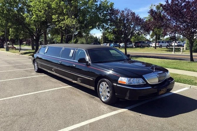 Black limousine parked in a parking lot, representing airport limo service in Kitchener, Ontario.