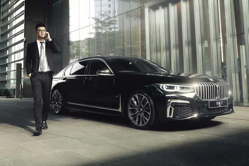 Executive man arriving in a luxury limousine, heading from Downtown Guelph to Airport Limo Service for a professional and comfortable ride.